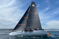 Sailing yacht "Blue Carbon" TP52, 2007 model, on open water with crew onboard.
