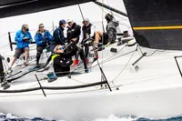 Sailors on a TP 52 yacht, model year 2007, racing on the ocean.