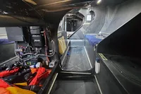Interior of a 2007 TP52 yacht, showcasing navigation equipment and compact sleeping quarters.