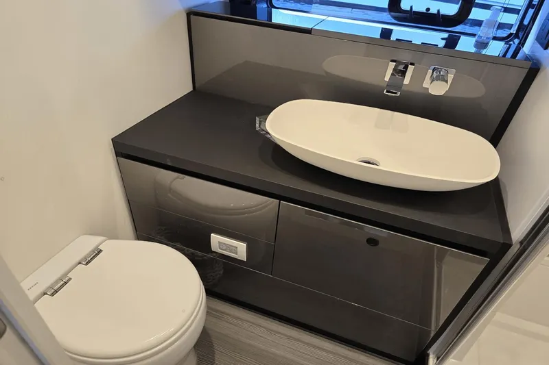 Making Memories II Yacht Photos Pics Modern bathroom in 2022 Azimut Verve 47 yacht with sleek sink and toilet.