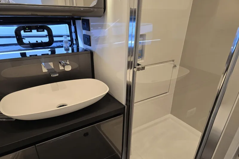 Making Memories II Yacht Photos Pics Modern bathroom in 2022 Azimut Verve 47 yacht with sleek sink and glass shower.