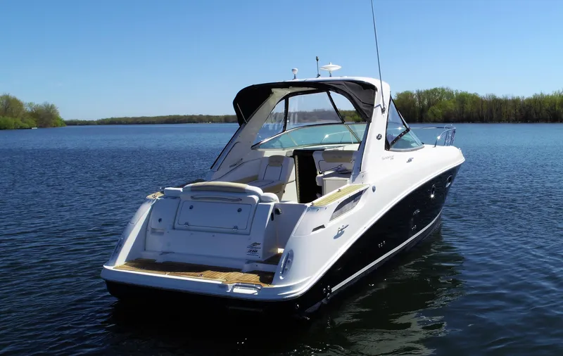  Yacht Photos Pics 2010 Sea Ray 310 Sundancer boat on a calm lake.
