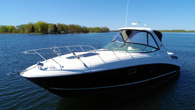  Yacht Photos Pics 2010 Sea Ray 310 Sundancer yacht on a serene lake.