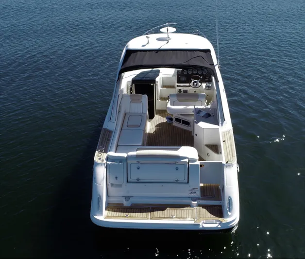  Yacht Photos Pics 2010 Sea Ray 310 Sundancer boat on calm water, rear view.