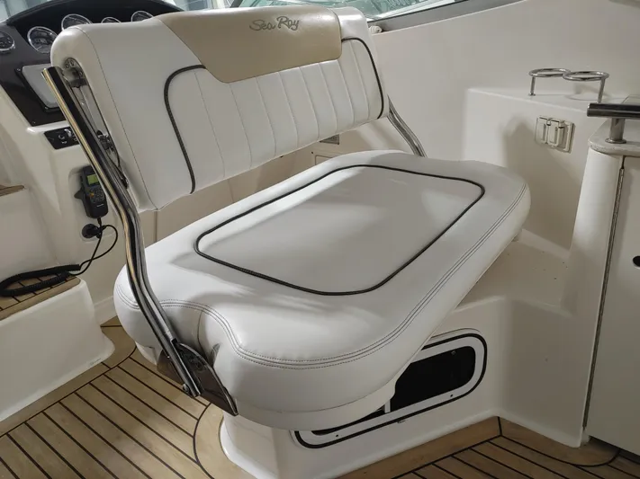  Yacht Photos Pics 2010 Sea Ray 310 Sundancer cockpit seating with white upholstery and teak flooring.