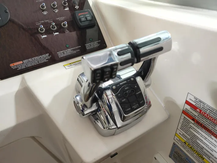  Yacht Photos Pics Close-up of the control panel and throttle of a 2010 Sea Ray 310 Sundancer boat.