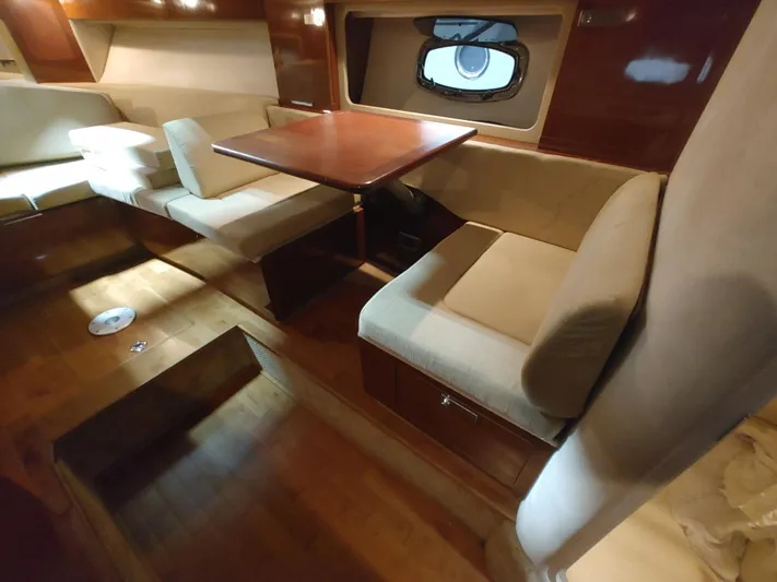  Yacht Photos Pics Interior of 2010 Sea Ray 310 Sundancer with dining area and wooden table.