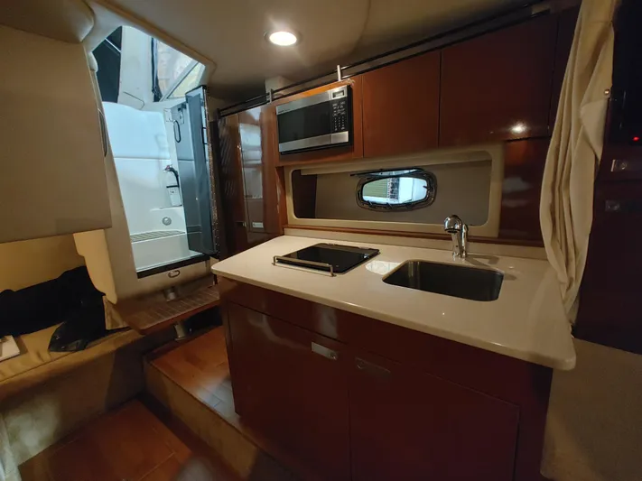  Yacht Photos Pics Interior of 2010 Sea Ray 310 Sundancer yacht with kitchenette and sink.