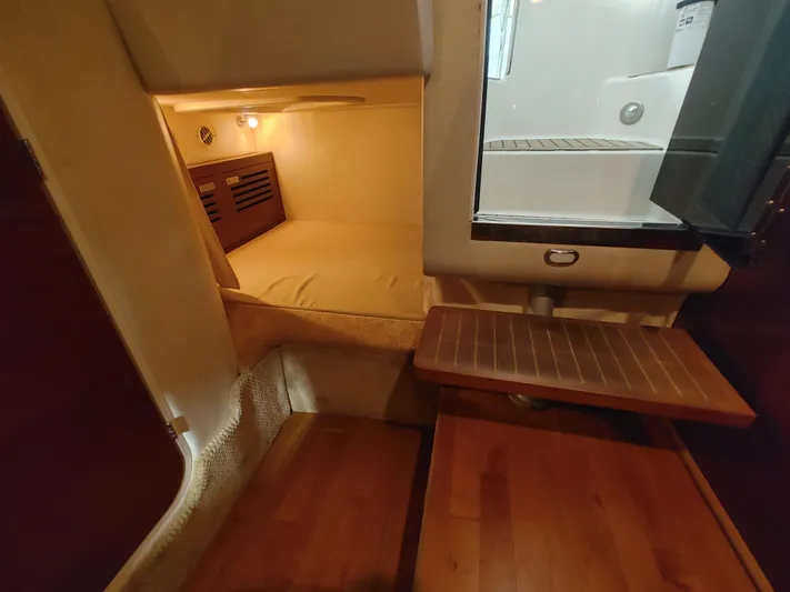  Yacht Photos Pics Interior cabin of a 2010 Sea Ray 310 Sundancer yacht with wooden flooring.