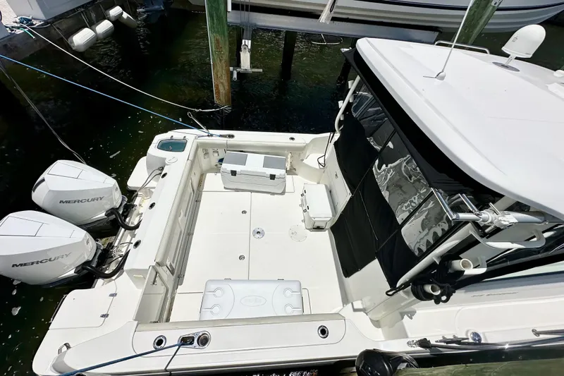Extra Vagancia Yacht Photos Pics 2015 Boston Whaler 315 Conquest boat with dual Mercury engines, docked in marina.