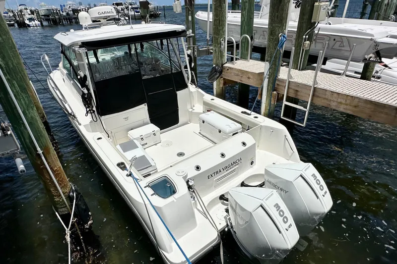 Extra Vagancia Yacht Photos Pics 2015 Boston Whaler 315 Conquest docked, featuring twin Mercury engines.