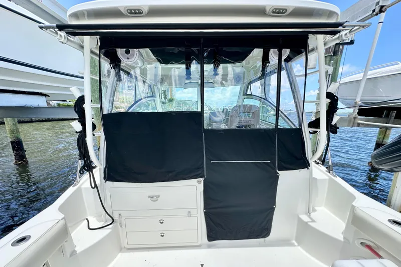 Extra Vagancia Yacht Photos Pics 2015 Boston Whaler 315 Conquest boat interior with covered cockpit and clear windows.