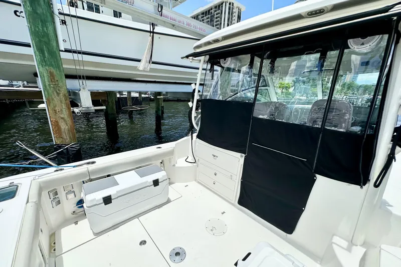 Extra Vagancia Yacht Photos Pics 2015 Boston Whaler 315 Conquest boat interior with seating and storage.