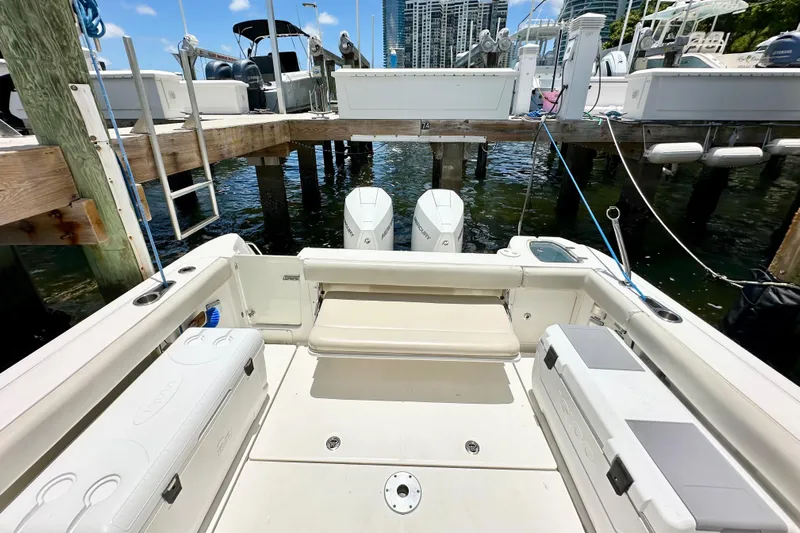 Extra Vagancia Yacht Photos Pics 2015 Boston Whaler 315 Conquest docked, showcasing spacious deck and twin engines.