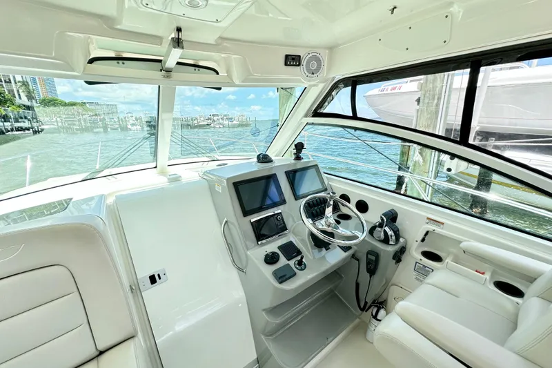 Extra Vagancia Yacht Photos Pics 2015 Boston Whaler 315 Conquest helm with modern controls and waterfront view.