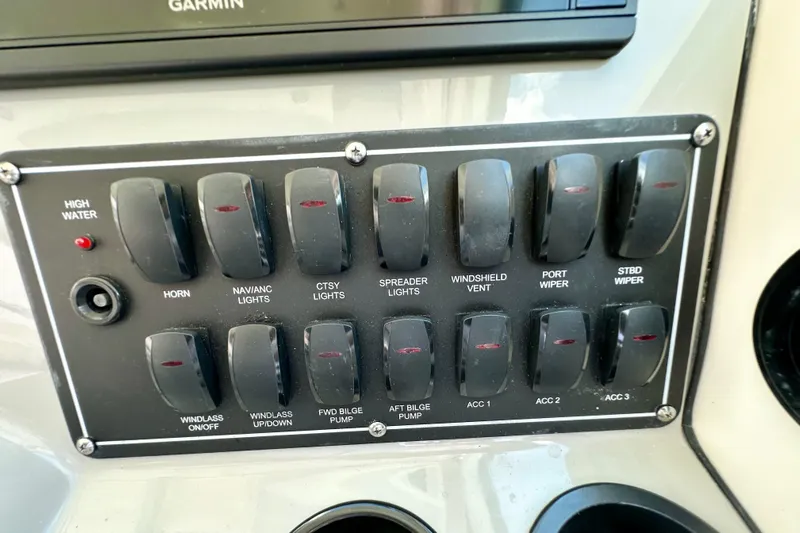 Extra Vagancia Yacht Photos Pics Control panel of a 2015 Boston Whaler 315 Conquest boat with labeled switches.