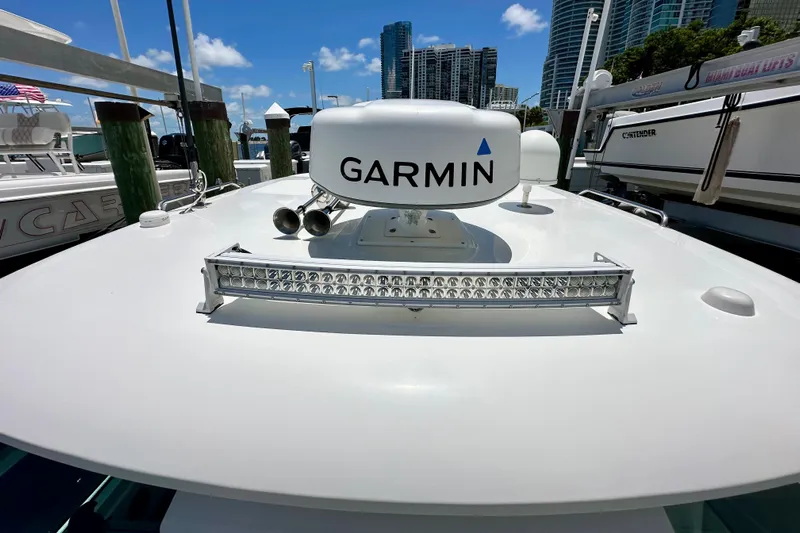 Extra Vagancia Yacht Photos Pics 2015 Boston Whaler 315 Conquest with Garmin radar, docked in a marina.