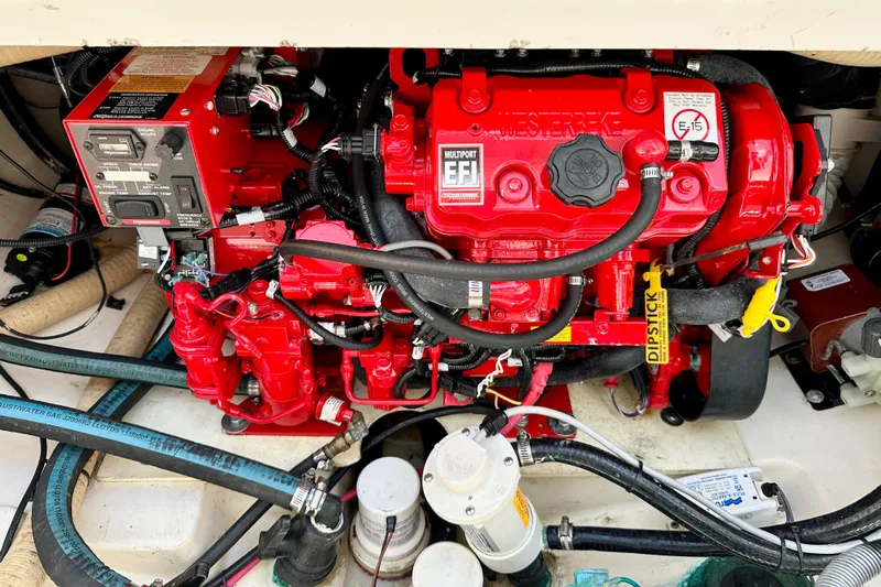 Extra Vagancia Yacht Photos Pics Engine compartment of a 2015 Boston Whaler 315 Conquest, featuring a red multiport EFI engine.
