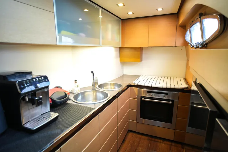 Freedom 2 Yacht Photos Pics Modern kitchen interior on 2010 Pershing 72 yacht with appliances and sleek design.