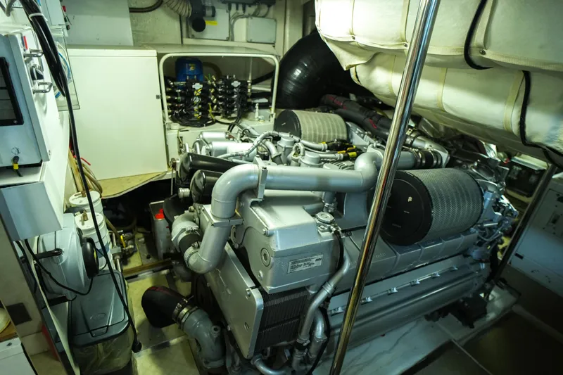Freedom 2 Yacht Photos Pics Engine room of a 2010 Pershing 72 yacht, showcasing complex machinery and components.