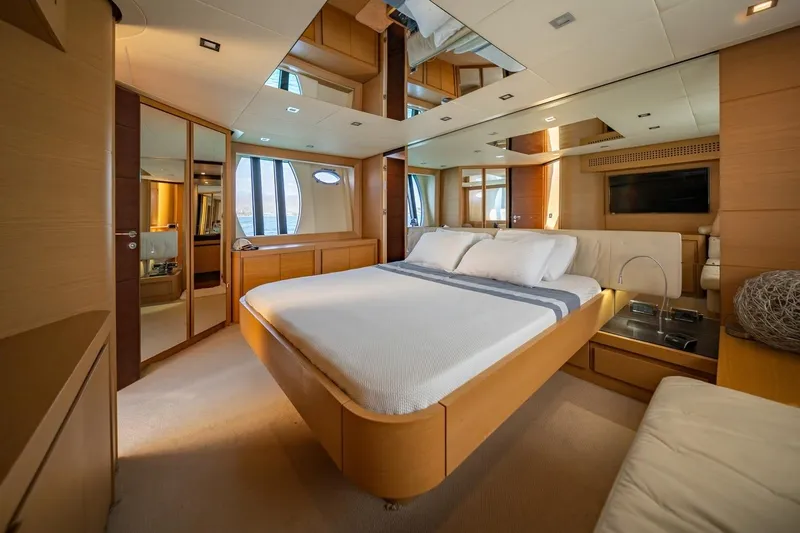 Freedom 2 Yacht Photos Pics Luxurious bedroom interior of a 2010 Pershing 72 yacht with modern design elements.