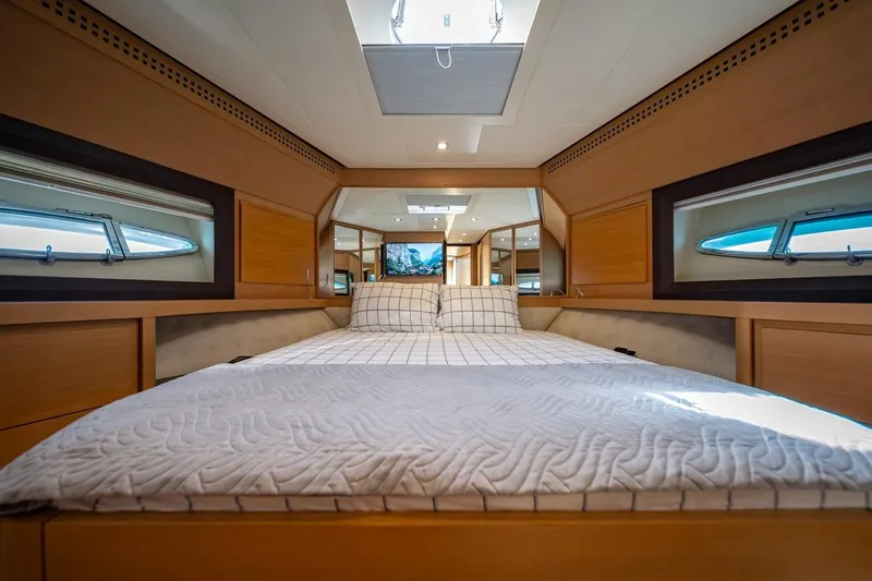 Freedom 2 Yacht Photos Pics Luxurious bedroom interior of 2010 Pershing 72 yacht with modern design and natural light.