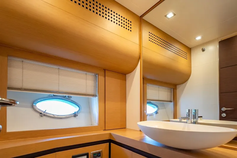 Freedom 2 Yacht Photos Pics Luxurious bathroom interior of 2010 Pershing 72 yacht with modern fixtures and wooden accents.