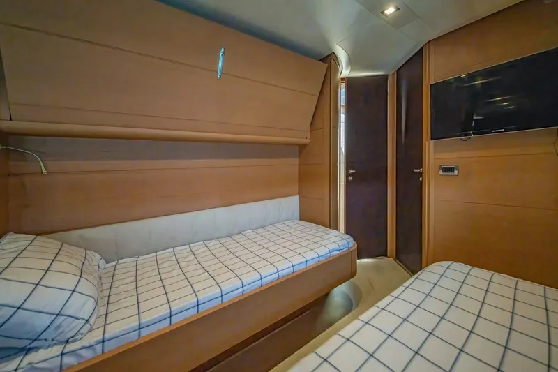 Freedom 2 Yacht Photos Pics Interior cabin of 2010 Pershing 72 yacht with twin beds and TV.