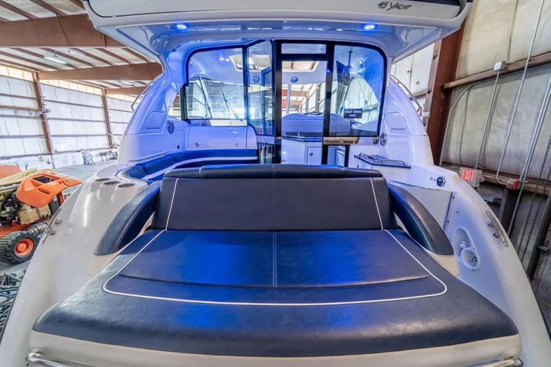 Beautiful Now Yacht Photos Pics 2015 Formula 45 Yacht interior with blue seating and modern design in a warehouse setting.