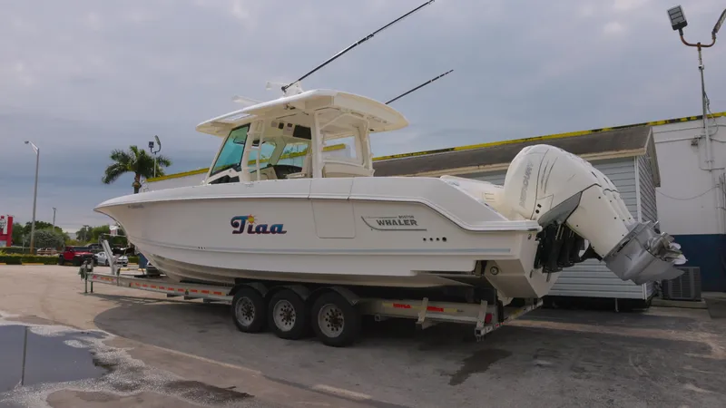  Yacht Photos Pics 2018 Boston Whaler 380 Outrage boat on trailer, parked outdoors.