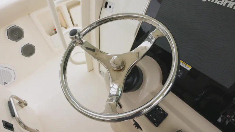  Yacht Photos Pics Steering wheel of a 2018 Boston Whaler 380 Outrage boat, featuring a sleek design.