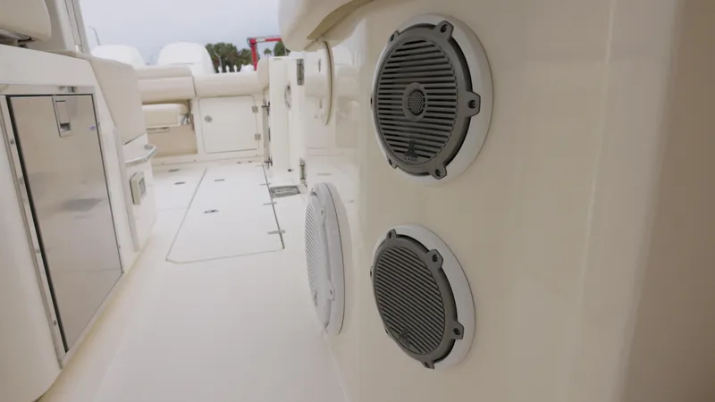  Yacht Photos Pics 2018 Boston Whaler 380 Outrage boat interior with speakers and seating area.