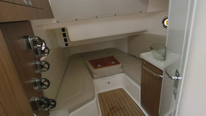  Yacht Photos Pics Interior cabin of 2018 Boston Whaler 380 Outrage, featuring seating and wooden accents.
