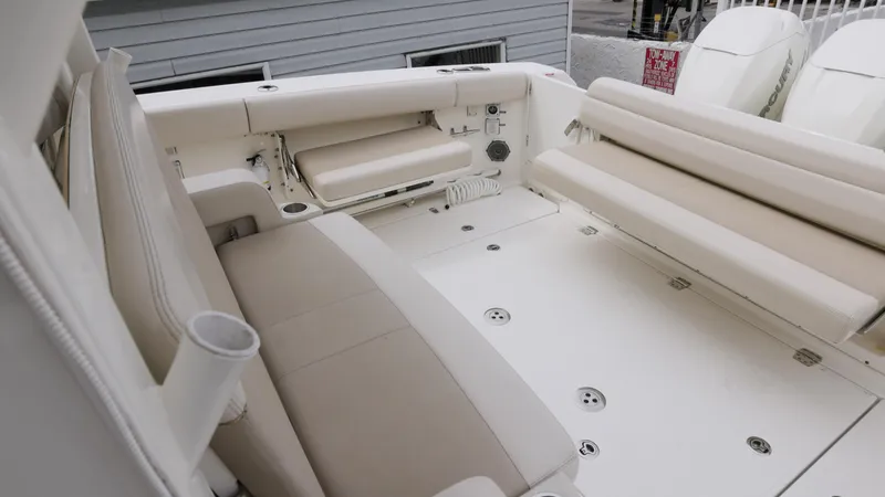  Yacht Photos Pics 2018 Boston Whaler 380 Outrage boat interior with beige seating and spacious deck area.
