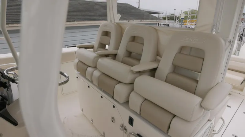  Yacht Photos Pics Luxury seating on 2018 Boston Whaler 380 Outrage boat, featuring plush, beige upholstery.