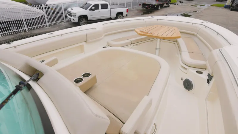  Yacht Photos Pics 2018 Boston Whaler 380 Outrage boat with spacious seating and table on deck.