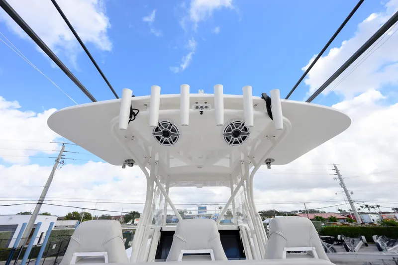 Seavee Yacht Photos Pics 2022 SeaVee 370Z boat with T-top, rod holders, and speakers against blue sky.