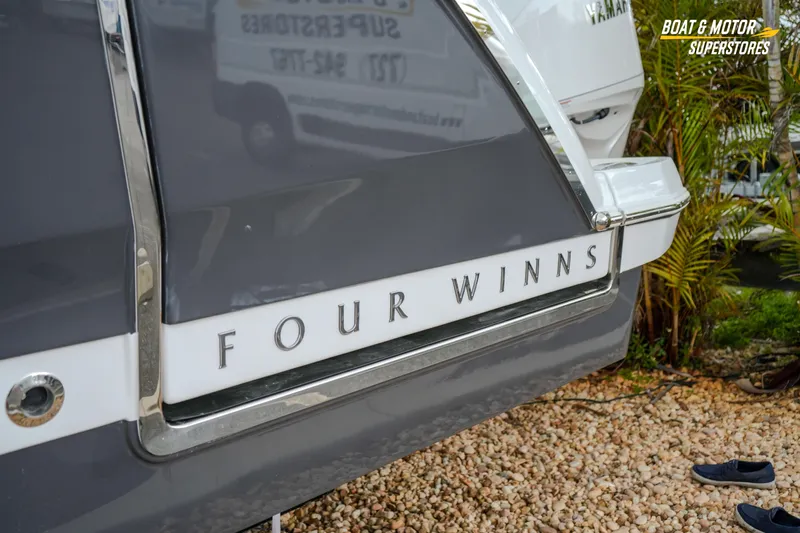  Yacht Photos Pics 2026 Four Winns H9 OB boat rear view with logo, displayed outdoors.
