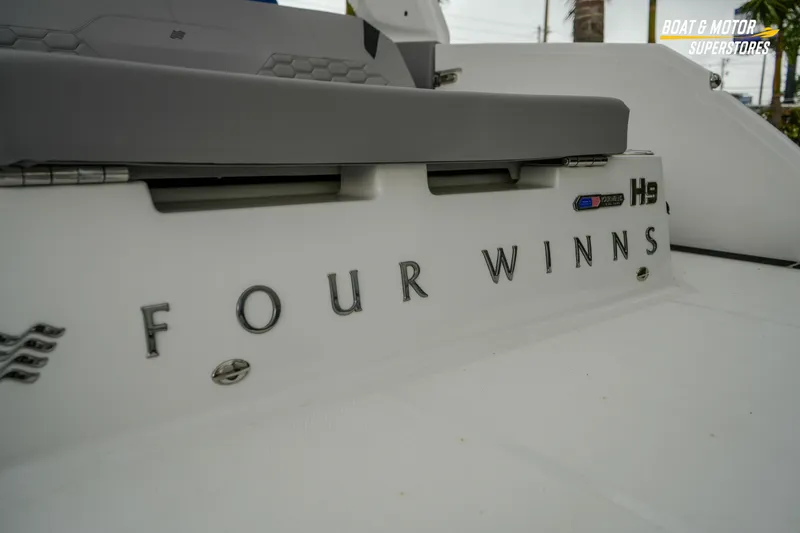  Yacht Photos Pics 2026 Four Winns H9 OB boat rear view with logo and seating detail.
