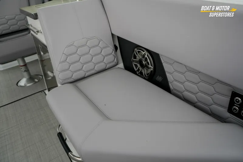  Yacht Photos Pics 2026 Four Winns H9 OB boat interior with hexagonal-patterned seating and integrated speaker system.