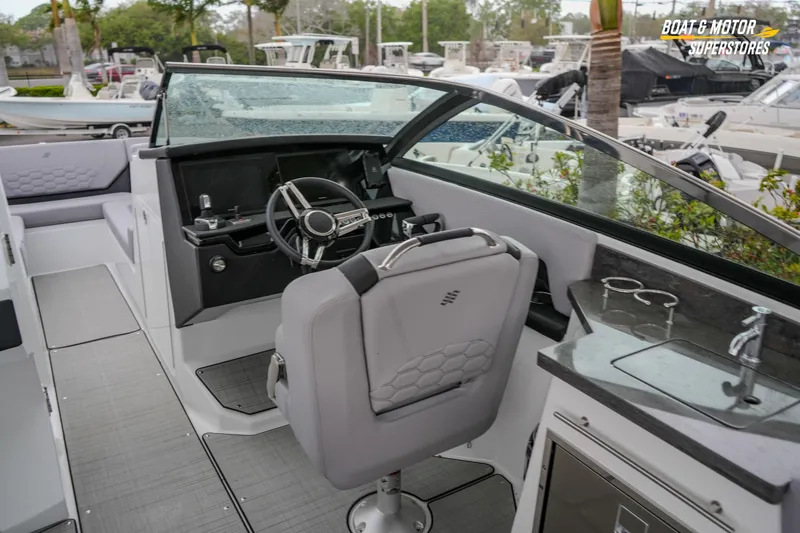  Yacht Photos Pics 2026 Four Winns H9 OB boat interior with steering wheel and seating area.