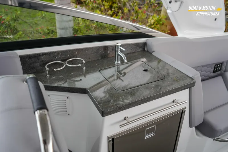  Yacht Photos Pics 2026 Four Winns H9 OB boat interior with sleek kitchenette and modern fixtures.