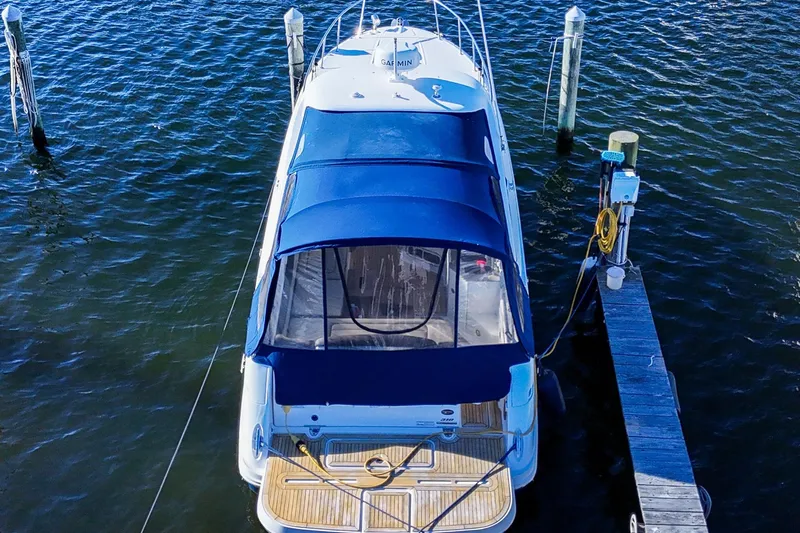  Yacht Photos Pics 2015 Sea Ray 310 Sundancer docked, aerial view, blue canopy, wooden deck.