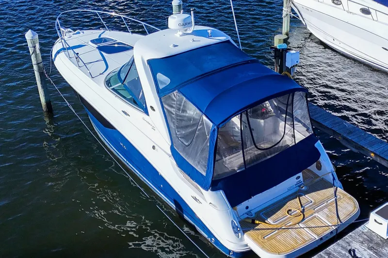 Yacht Photos Pics 2015 Sea Ray 310 Sundancer docked, featuring blue canopy and sleek design.