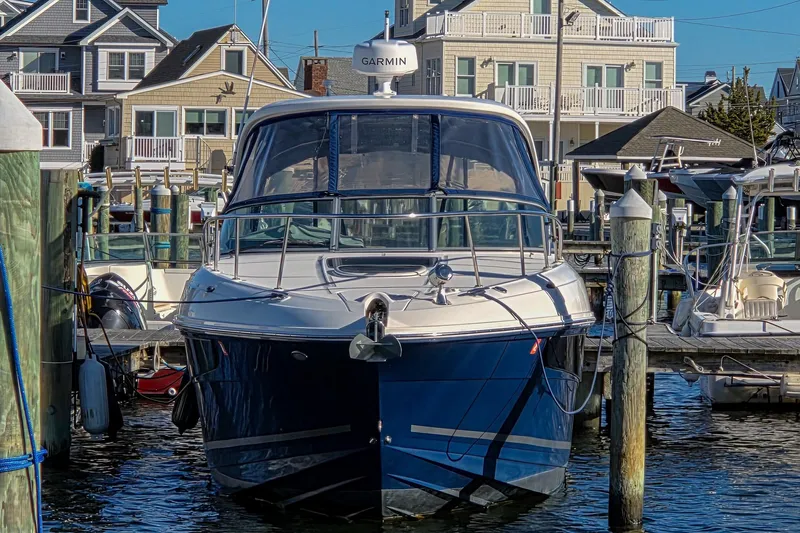  Yacht Photos Pics 2015 Sea Ray 310 Sundancer docked at marina with waterfront homes in background.
