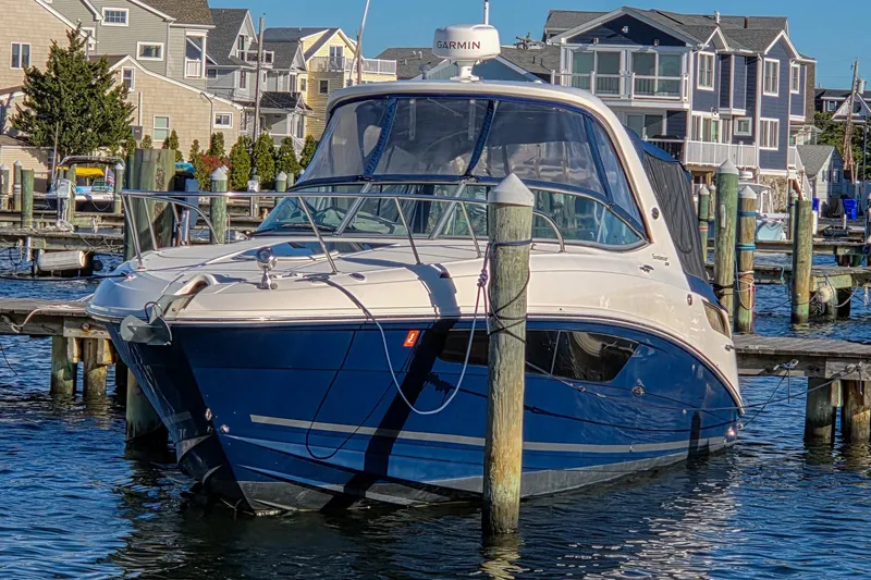  Yacht Photos Pics 2015 Sea Ray 310 Sundancer docked at marina with waterfront homes in background.