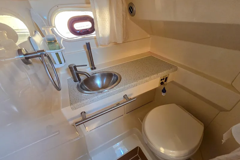 Yacht Photos Pics 2015 Sea Ray 310 Sundancer bathroom with sink, countertop, and toilet.