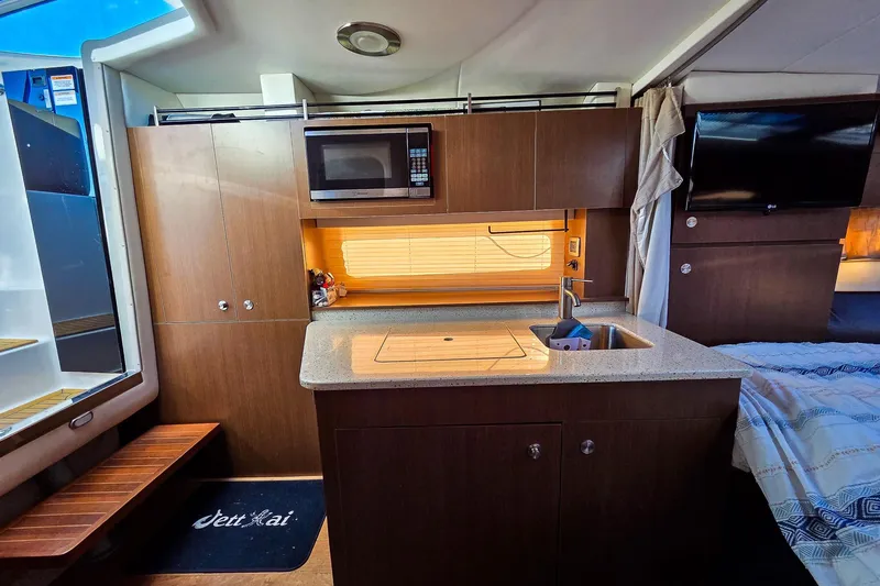  Yacht Photos Pics 2015 Sea Ray 310 Sundancer interior with kitchenette, microwave, and sink.