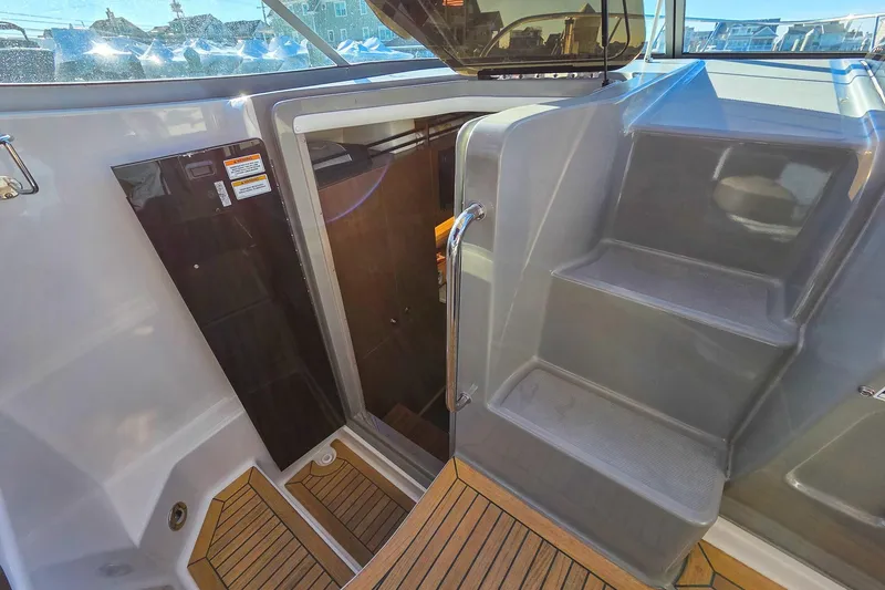  Yacht Photos Pics 2015 Sea Ray 310 Sundancer boat interior with stairs and wooden flooring.