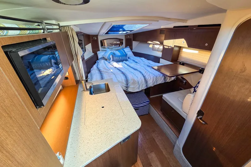  Yacht Photos Pics 2015 Sea Ray 310 Sundancer cabin interior with bed, kitchenette, and seating area.